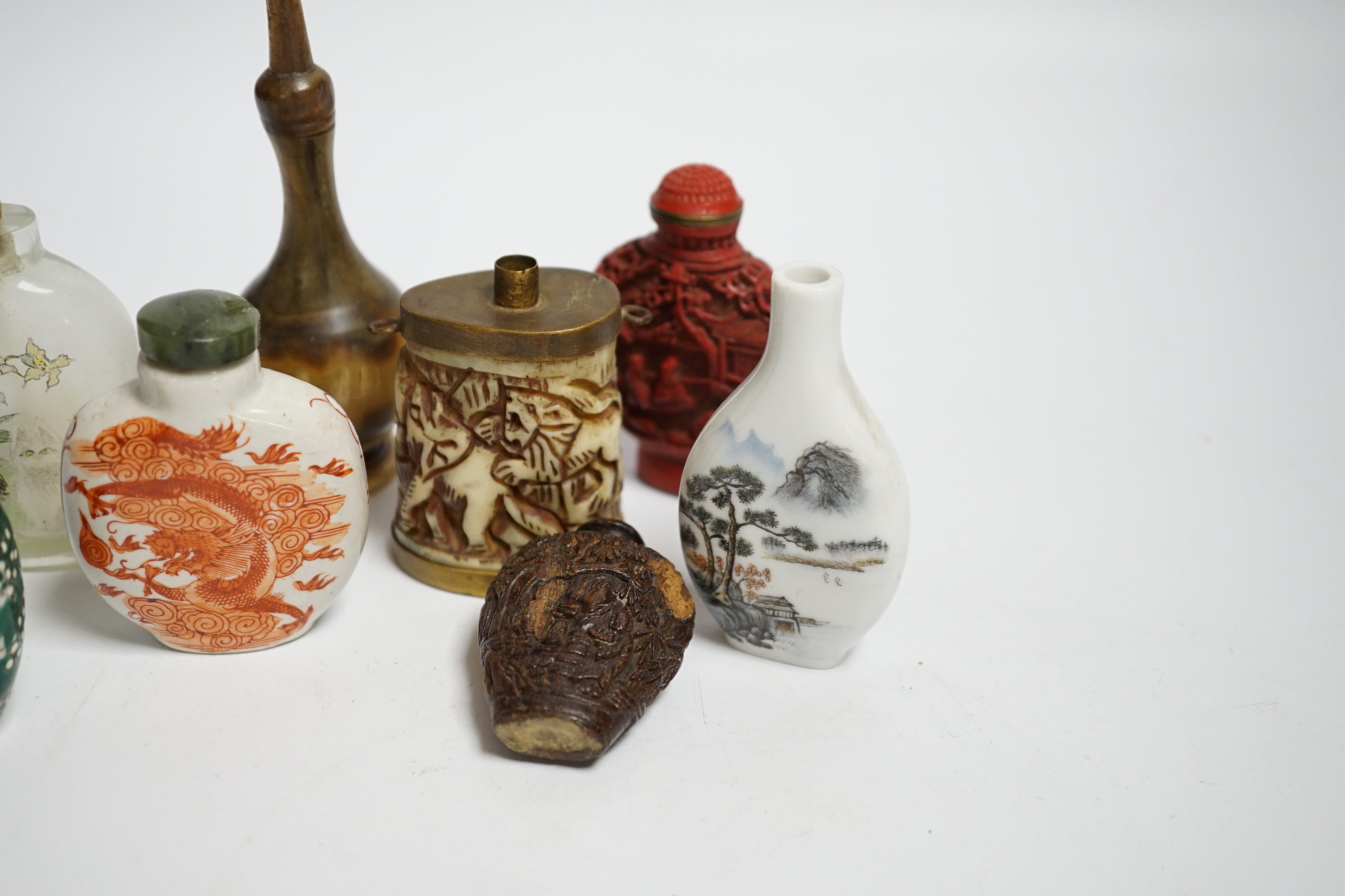 Seven various Chinese snuff bottles including horn, simulated lacquer, porcelain, glass, wood and a small bone powder flask